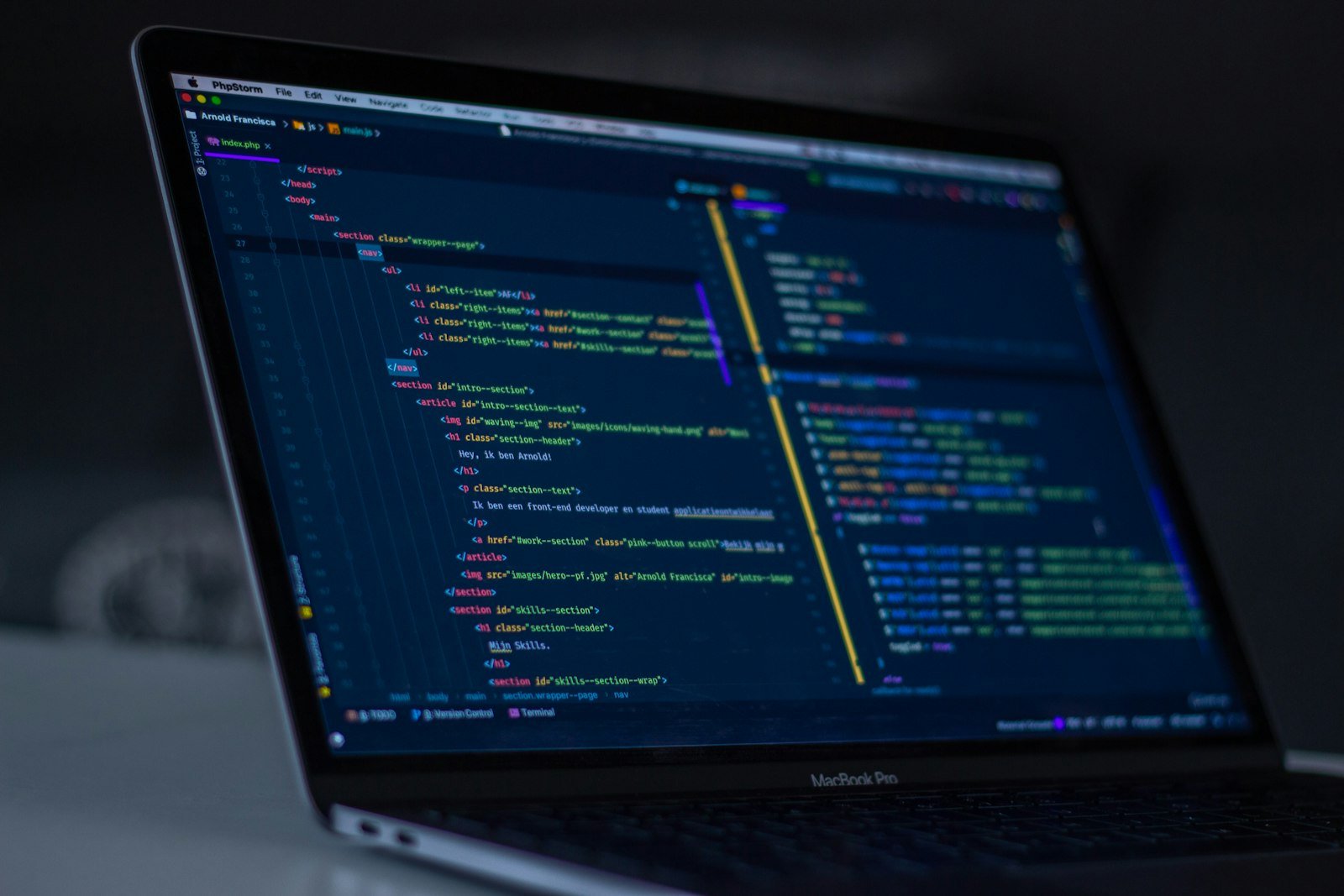 Laptop screen showing a code editor with a project file structure, representing the llms.txt technical implementation guide
